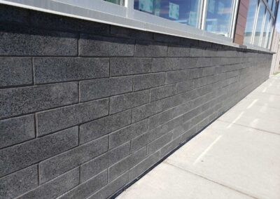 Gray brick base siding wall. Airdrie Choice Properties